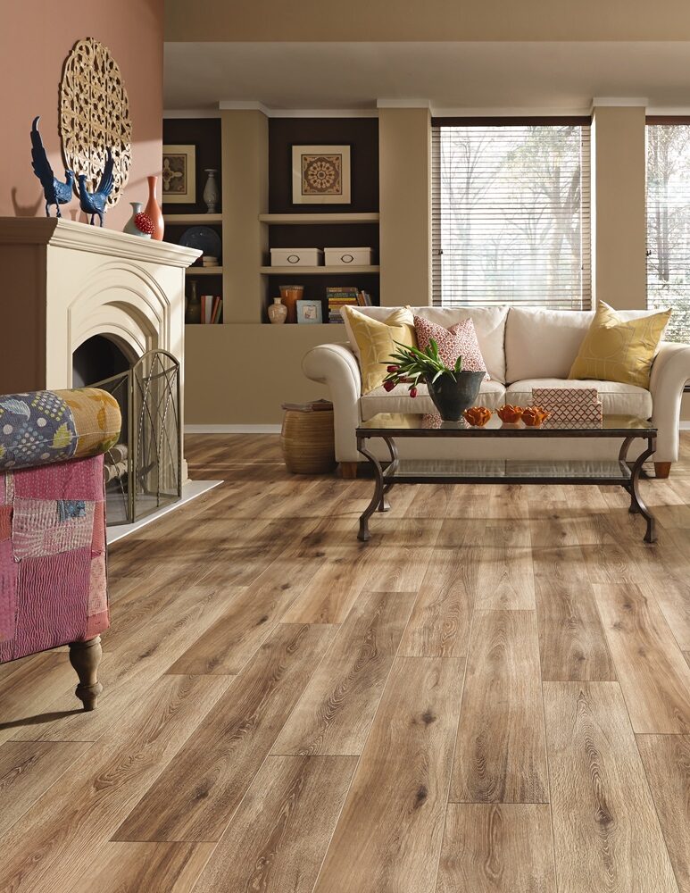 Traditional living room with beige sofa, fireplace, and medium brown wood plank flooring.